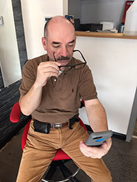 Man with glasses reading phone